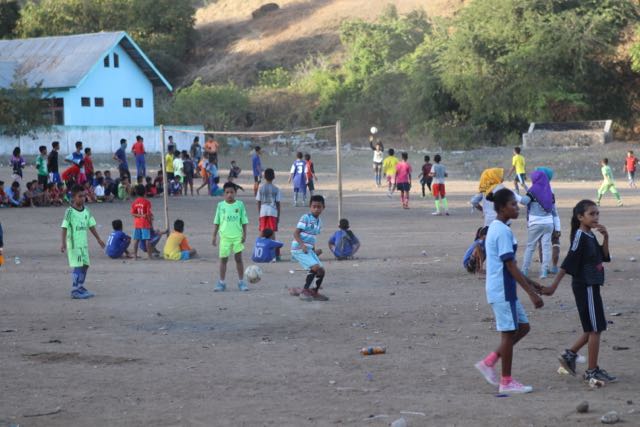 Kids playing football in village yard